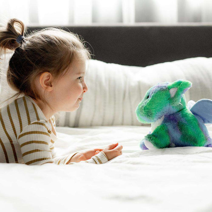 Little girl looking at Cute Weighted Lavender Scented Baby Dragon Stuffed Animal Heating Pad Warmies