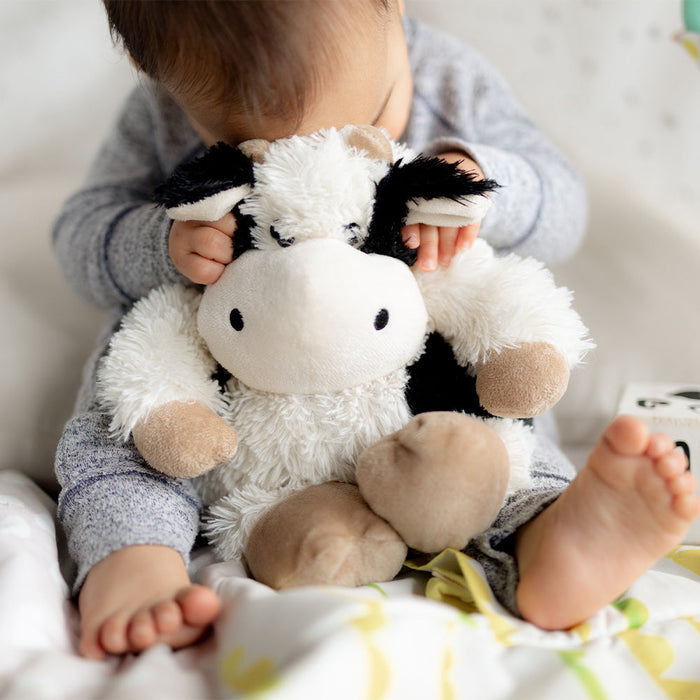 Baby cuddling Soft Lavender Scented Black and White Cow Warmies
