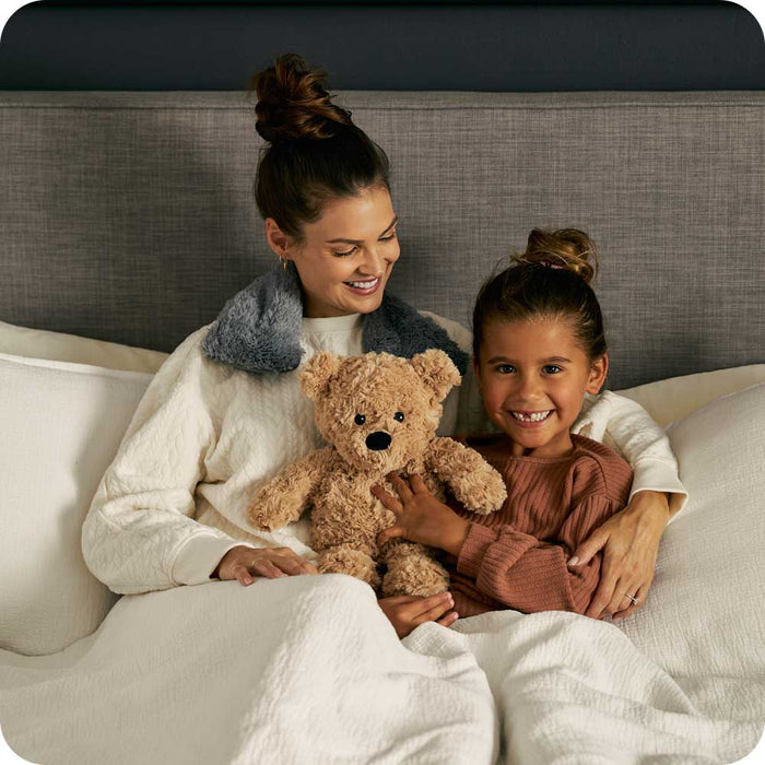 Mother and daughter holding a Soft Lavender Scented Brown Curly Bear Warmies