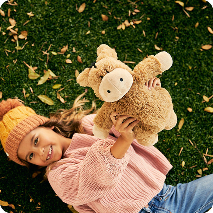 autumn lifestyle girl holding donkey stuffed animals