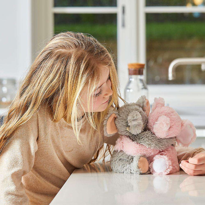 Child smiling and looking at Cute Weighted Lavender Scented Elephant Hugs Stuffed Animal Heating Pad Warmies