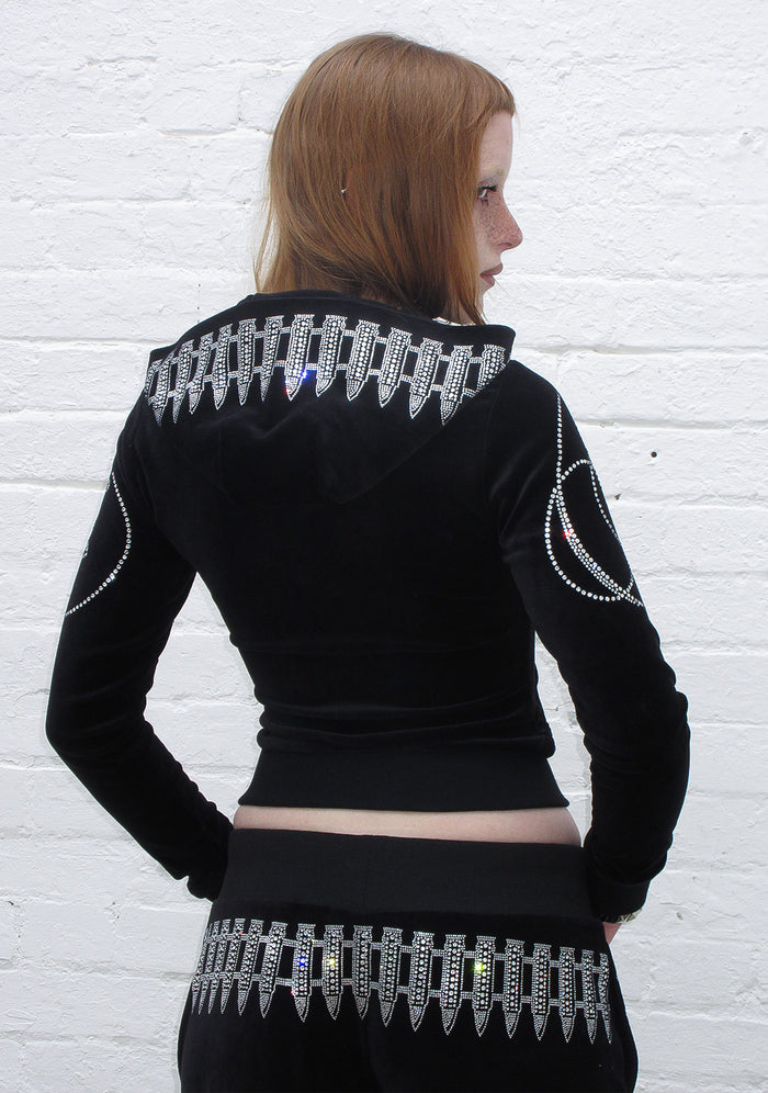 Back view of a black hoodie featuring rhinestones and bullet design embellishments on the hood.