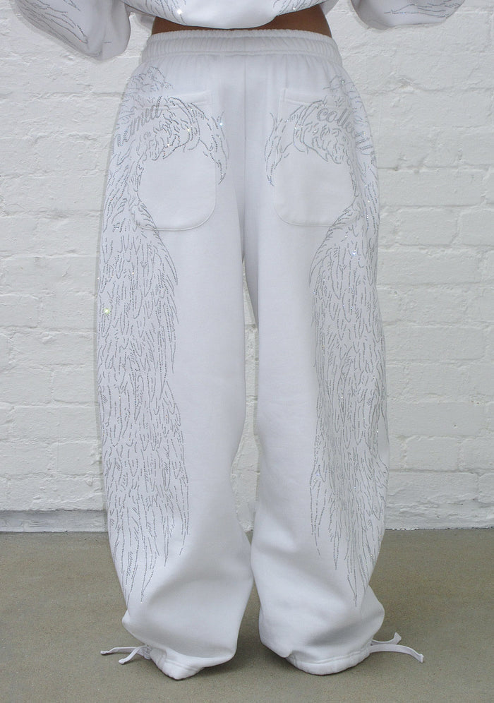 Front view of white sweatpants featuring rhinestone wing design and two back pockets.