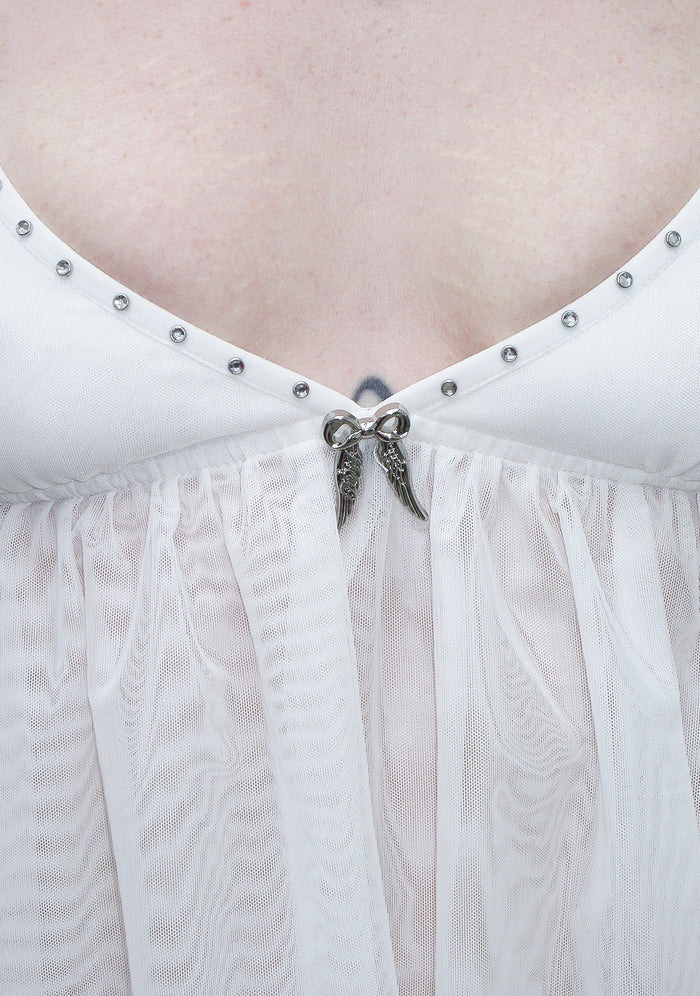 Close-up of fallen sheer mesh wings cami top white featuring rhinestones and wing embellishment detail.