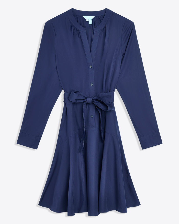 The Imogen Mini Shirtdress by Draper James features navy blue cotton, long sleeves, front buttons, a V-neckline, and a matching belt at the waistâ€”perfect as a chic work dress.