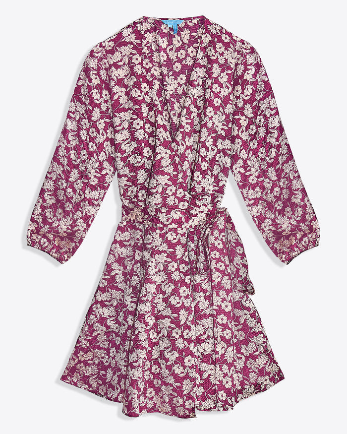 The Jordan Long-Sleeve Wrap Dress in Hammered Satin by Draper James features a pink base with white floral print, knee-length cut, wrap front, long sleeves, and a matching fabric waist tie.