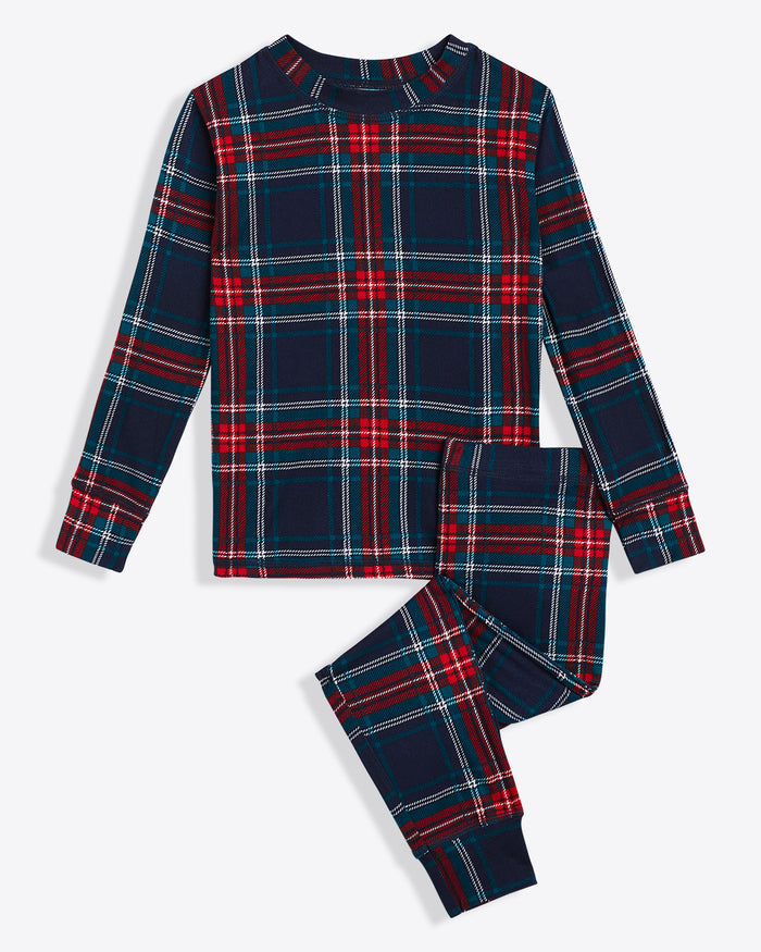The Draper James Kids Crewneck Pajama Set in Georgia Plaid features a festive long-sleeve top and pants with red, blue, and white stripes, making it the perfect cozy ensemble to keep kids snug through the night during the holidays.