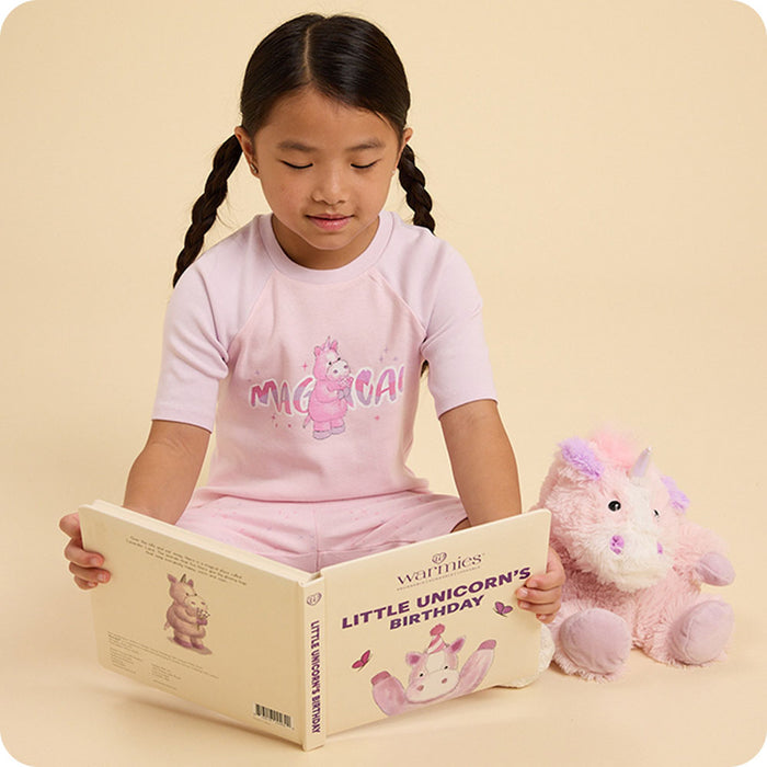 Girl reading Little Unicorn's Birthday warmies book