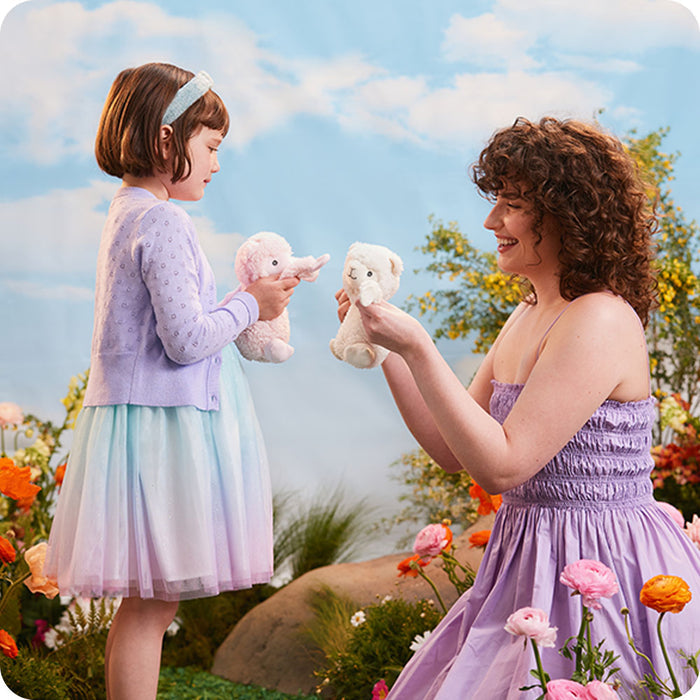 mother and daughter playing with llama hugs stuffed animal warmies