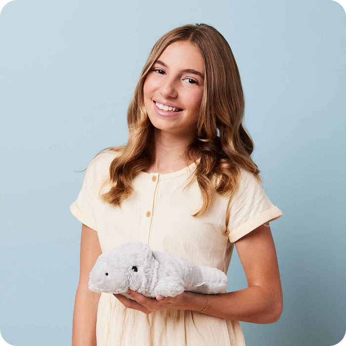 Teen holding Soft Warm Weighted Manatee Plush Warmies