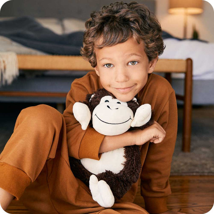 Boy hugging Cute Weighted Lavender Scented Monkey Stuffed Animal Heating Pad Warmies