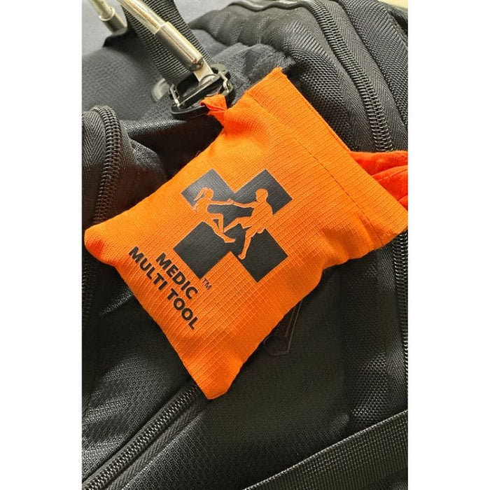Orange MEDIC MULTI TOOL pouch attached to a black bag