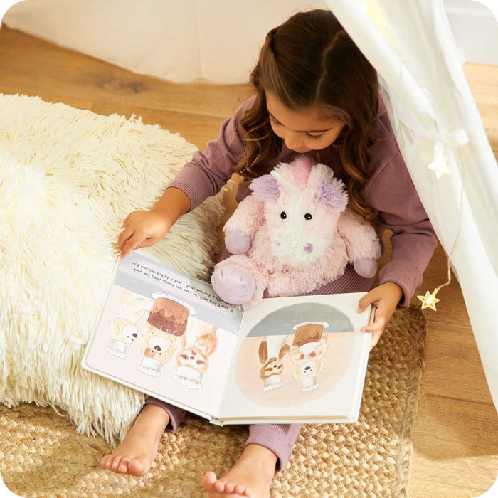 Girl reading book with Cute Weighted Lavender Scented Unicorn Stuffed Animal Heating Pad Warmies