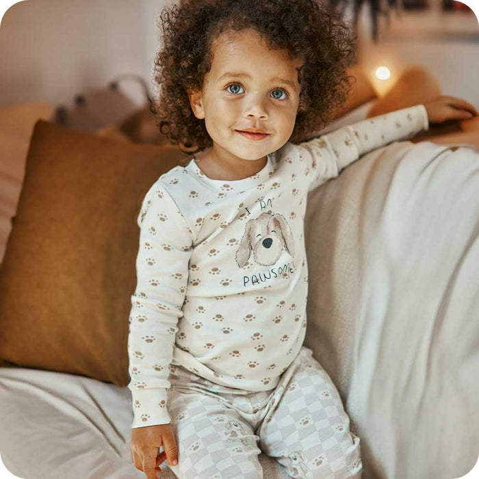 Toddler smiling while wearing Puppy Pajamas - Warmies USA