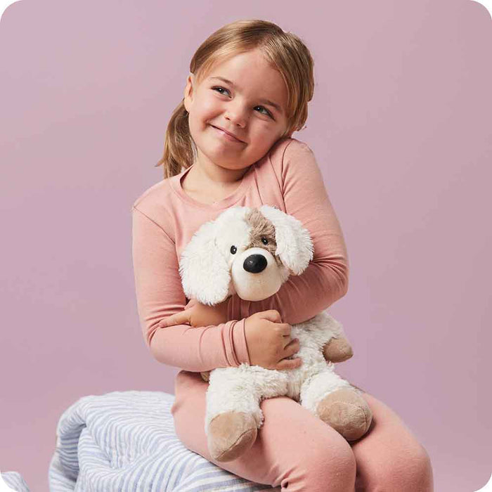 Girl hugging Soft Warm Weighted Puppy Warmies
