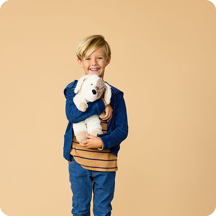 boy holding puppy stuffed animal