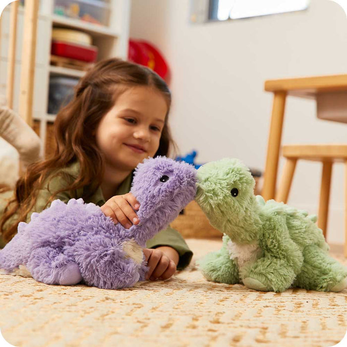 Child playing with Soft Warm Weighted Purple Long Neck Dinosaur Plush Warmies