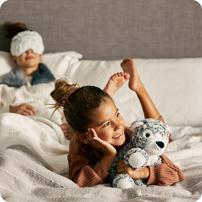 mother and daughter cozy with snow leopard stuffed animal
