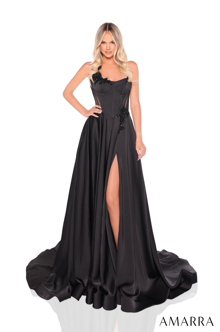 A model wears a long black evening gown with a high slit and beaded bodice by Amarra.