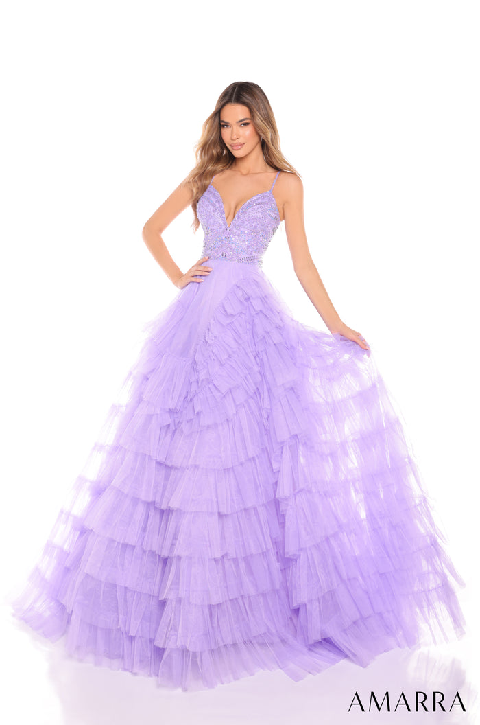 A model wears a lilac tiered tulle ball gown with a beaded bodice and thin straps.