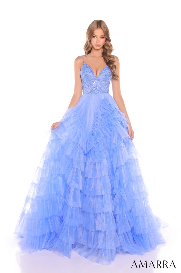 A model wears a periwinkle tiered tulle ball gown with a beaded bodice and spaghetti straps by Amarra.