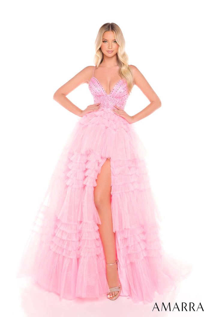 A flowing Candy Pink tiered tulle gown with a beaded bodice and high leg slit, styled on a model.