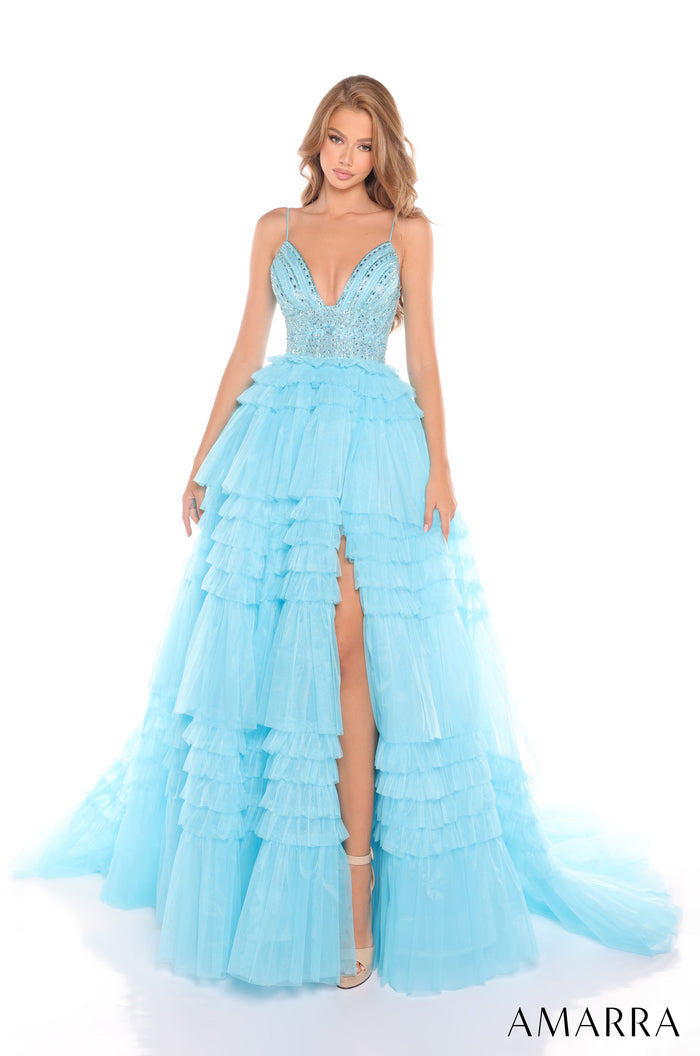 A floor-length, tiered light blue tulle gown with a beaded bodice and thigh-high slit, styled on a model.