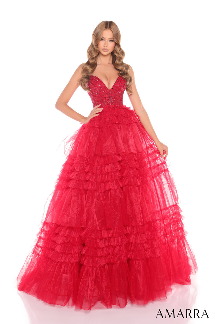 A woman wears a voluminous, tiered Red ball gown with a sparkling bodice and ruffled tulle skirt.