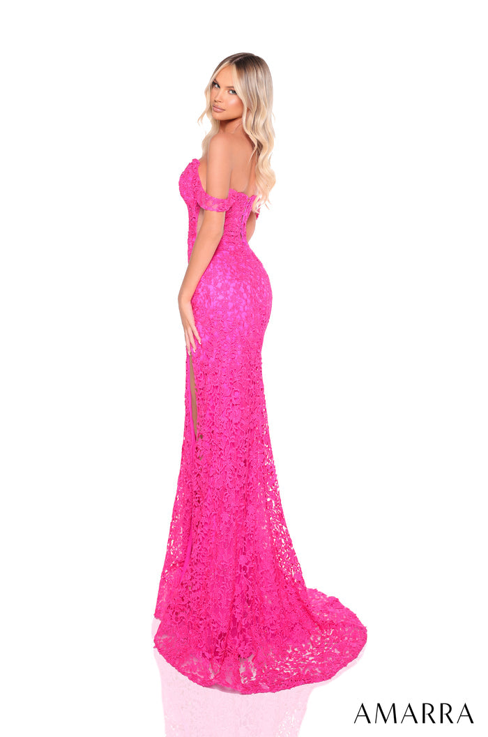 A blonde woman wears a vibrant pink lace off-shoulder mermaid gown with a long train.