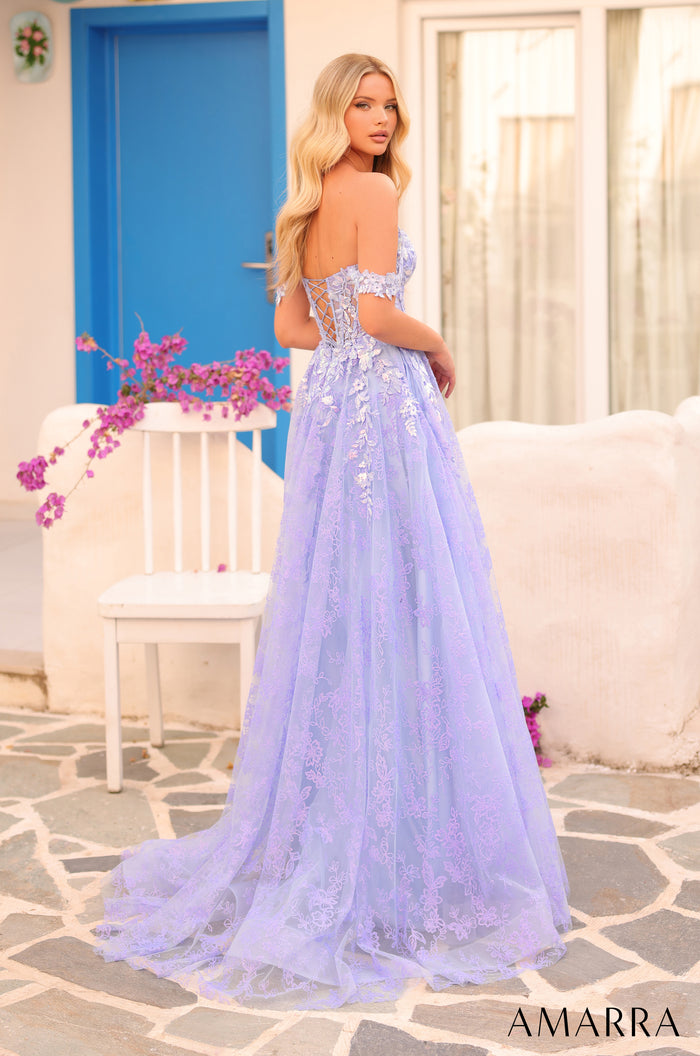 A lavender lace corset gown with an off-shoulder design, photographed against a blue door and stone backdrop.
