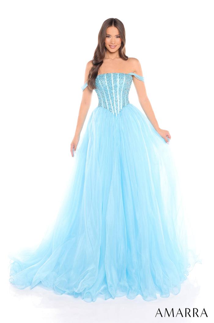 A woman wears a voluminous turquoise off-shoulder ball gown with a sparkling corset-style bodice.