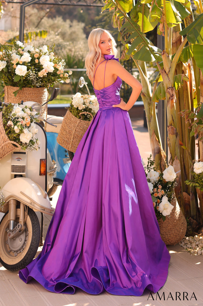 A blonde woman in a purple satin gown poses beside a vintage scooter with floral baskets.