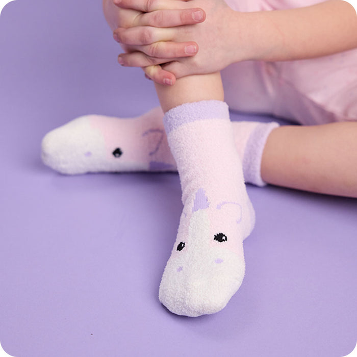 kids unicorn socks on purple background