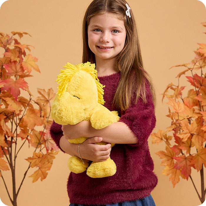 girl hugging snoopy stuffed animal